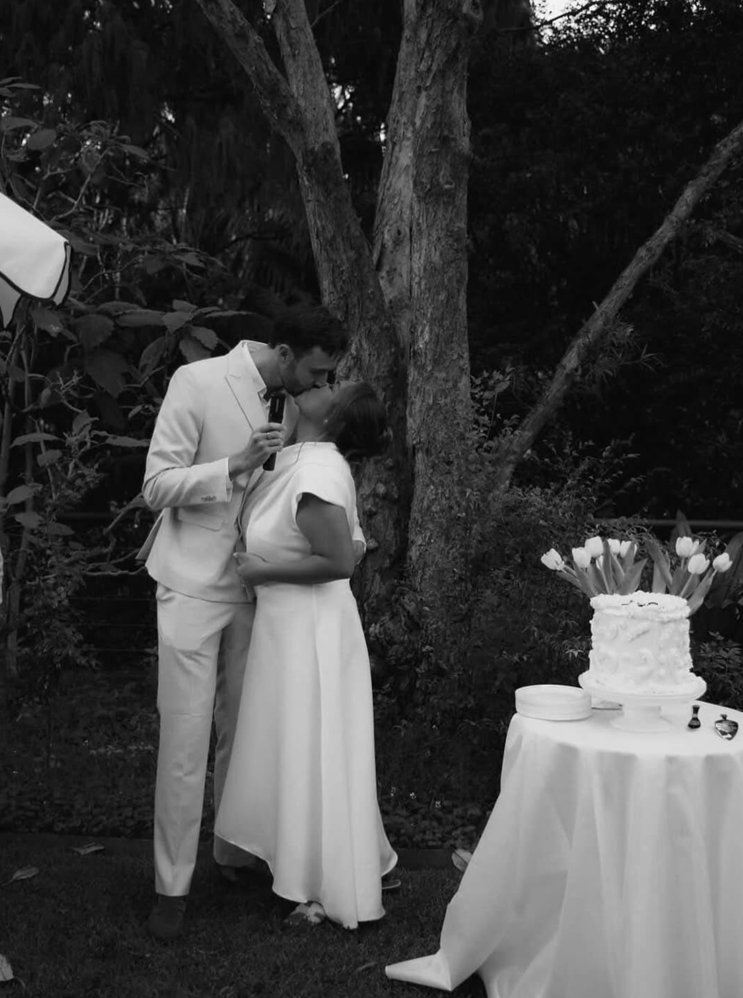 Couple celebrating with a custom Mimo Desserts wedding cake